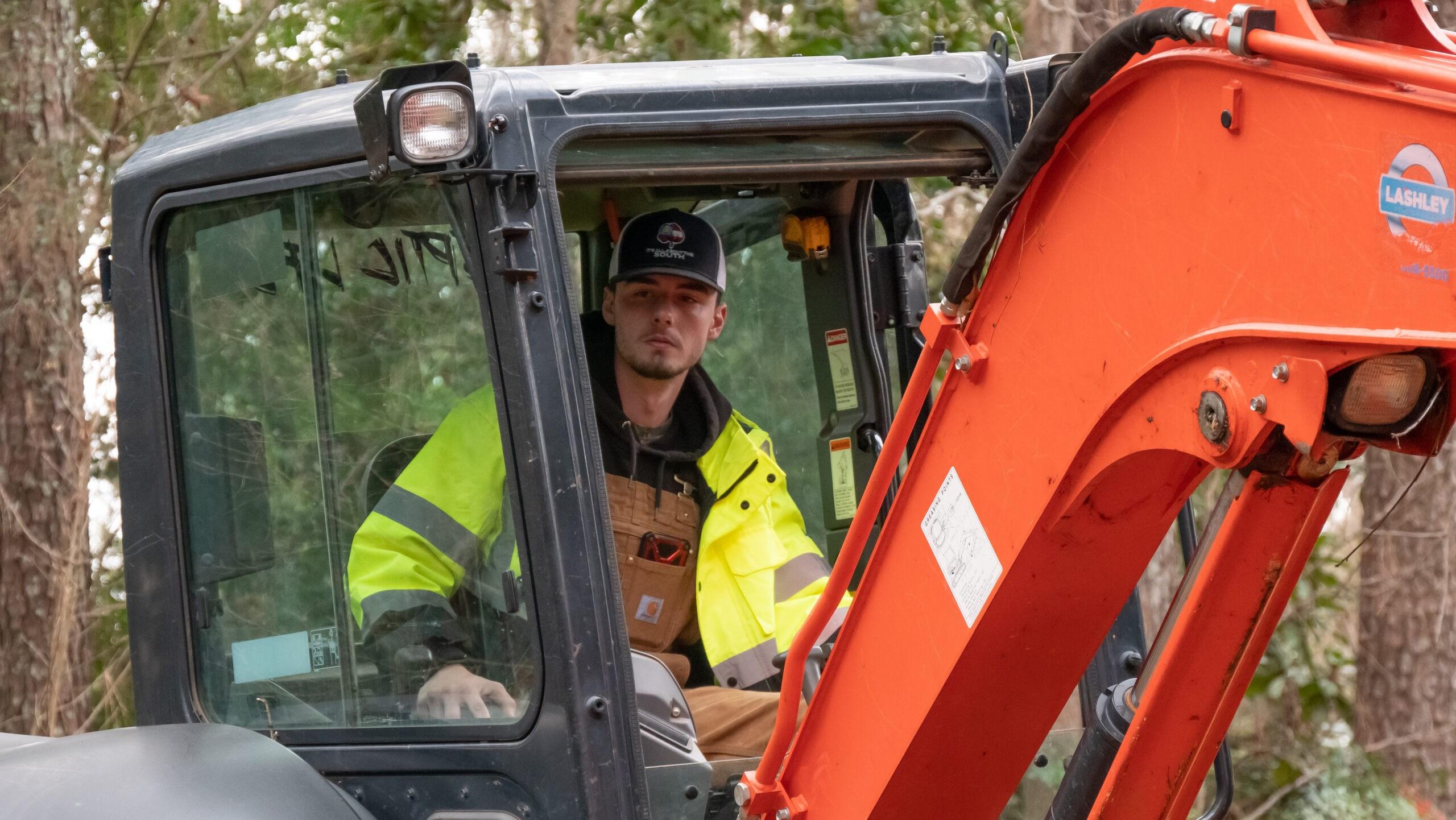 Grump's Pumps & Septic Employee operating equipment